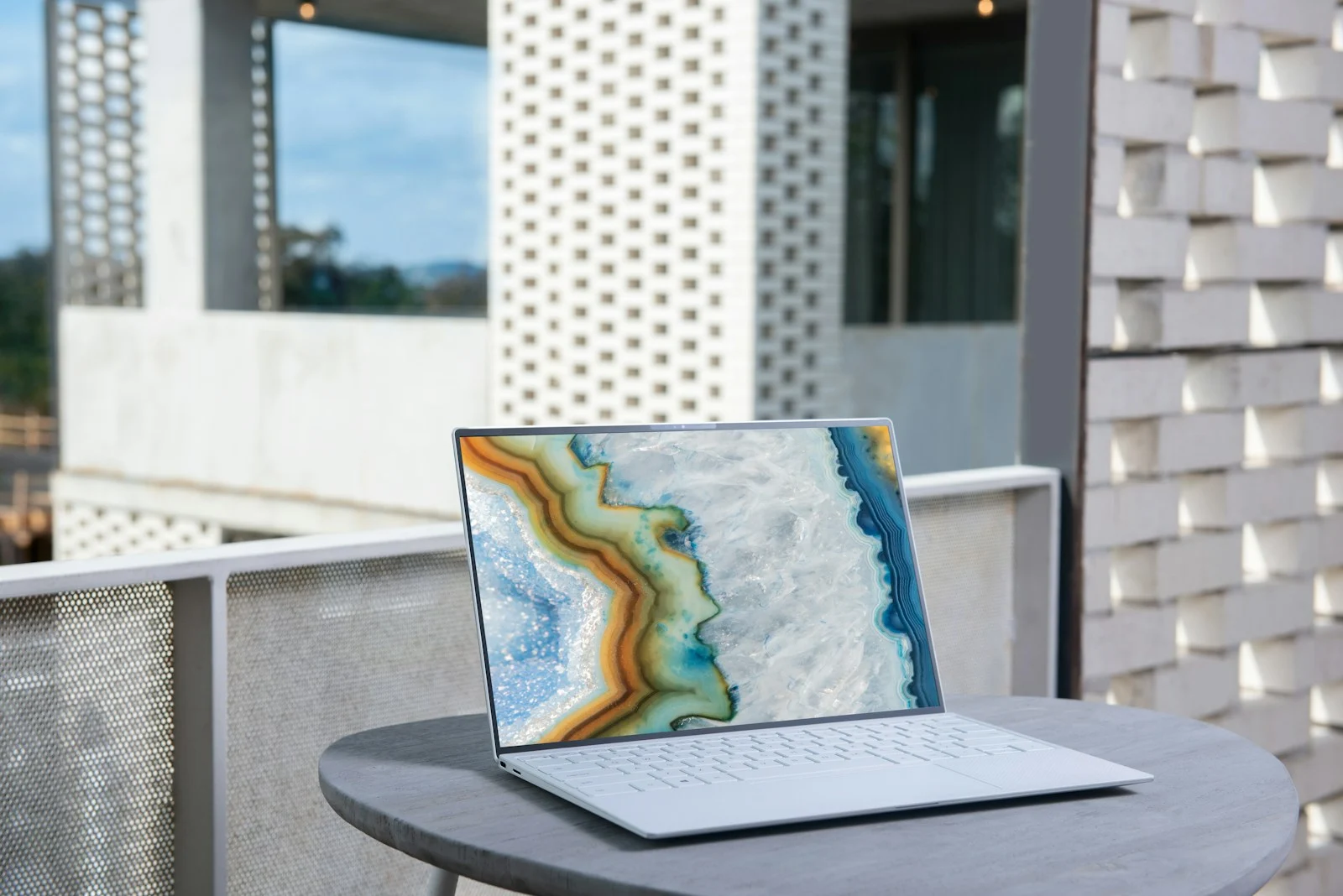 Premium business laptop photographed in an architectural silver setting